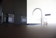 Čistý design kuchyně s minimalistickými úchytkami.